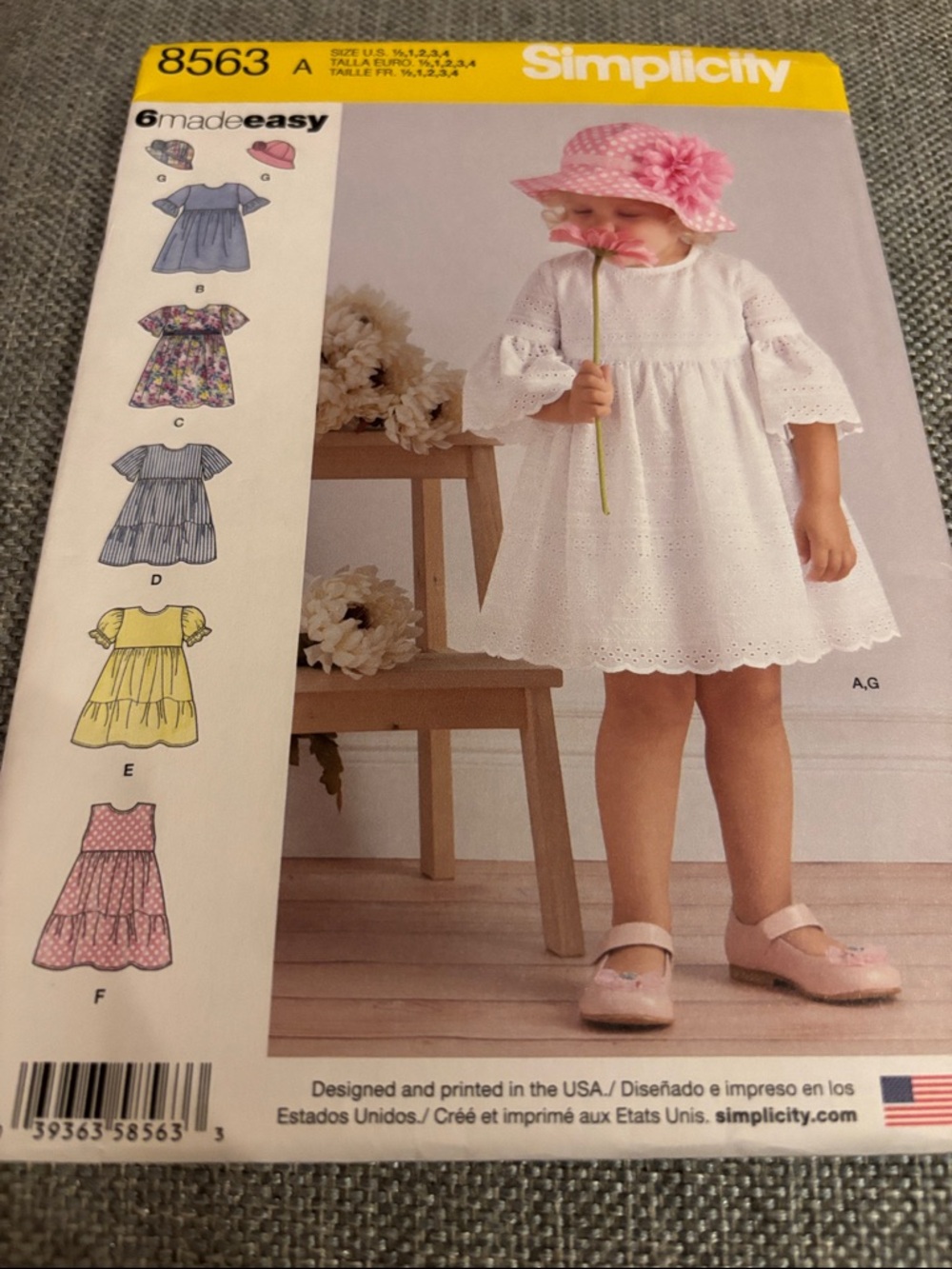 Simplicity sewing pattern kit for toddler dresses and a hat, model 8563.